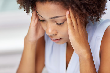 Image showing close up of african young woman touching her head