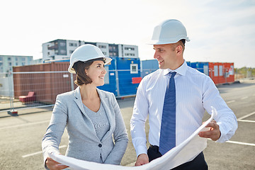 Image showing happy architects with blueprint at building