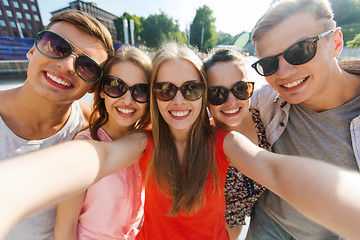 Image showing smiling friends taking selfie