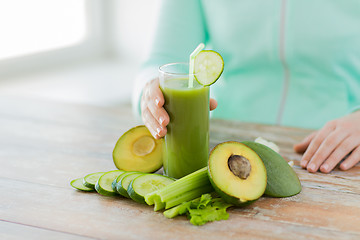 Image showing close up of woman hands with juice and vegetables