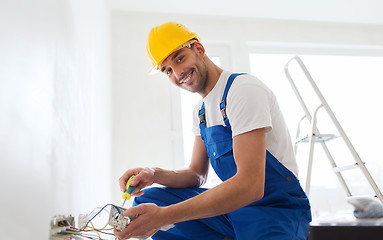 Image showing builder with tablet pc and equipment indoors
