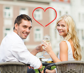 Image showing smiling couple drinking wine in cafe