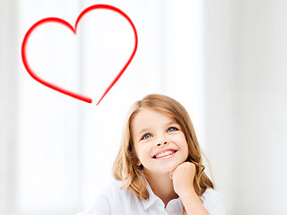 Image showing smiling little student girl drawing at school