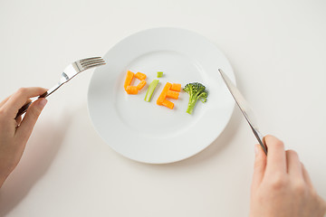 Image showing close up of woman hands eating vegetables