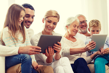 Image showing smiling family with tablet pc at home