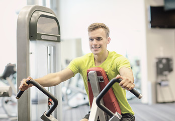 Image showing smiling man exercising in gym