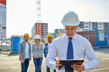 Image showing happy builders and architect at construction site