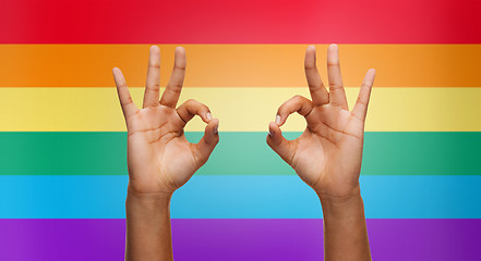 Image showing hands showing ok sign over rainbow background