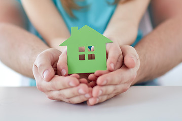 Image showing close up of man and girl hands with paper house