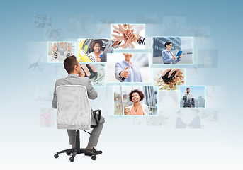 Image showing businessman sitting in office chair from back