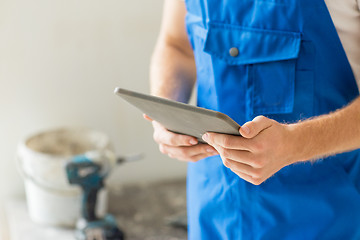 Image showing close up of builder or workman with tablet pc