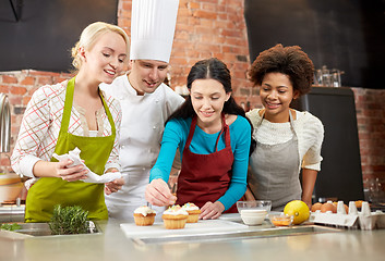 Image showing happy women and chef cook baking in kitchen