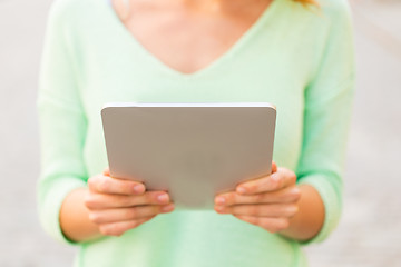 Image showing close up of woman with tablet pc outdoors