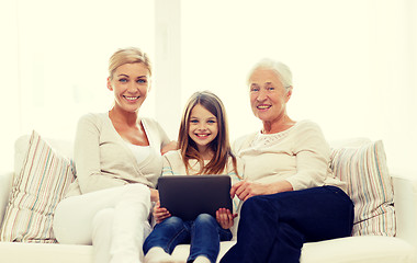 Image showing smiling family with tablet pc at home