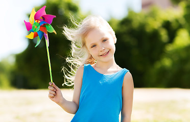 Image showing happy little girl with colorful pinwheel at summer