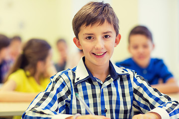 Image showing group of school kids writing test in classroom