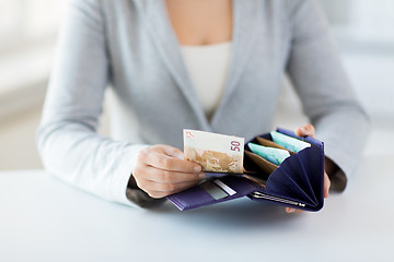 Image showing close up of woman hands with wallet and euro money