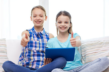 Image showing happy girls with tablet pc and showing thumbs up