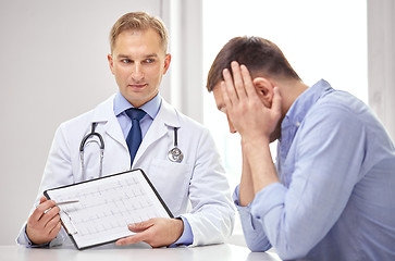 Image showing doctor and patient with cardiogram on clipboard