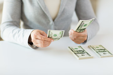 Image showing close up of woman hands counting us dollar money