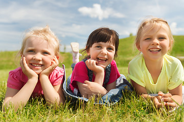 Image showing group of kids lying on blanket or cover outdoors