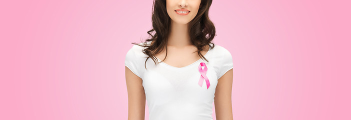 Image showing smiling young woman with cancer awareness ribbon