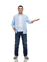 Image showing smiling man showing something on empty palm