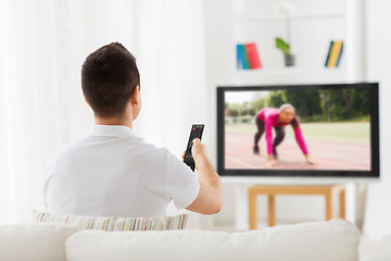 Image showing man watching sport channel on tv at home