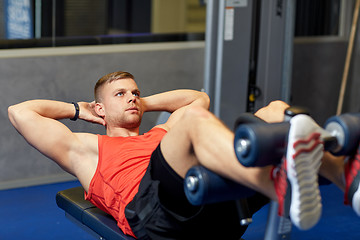 Image showing young man making abdominal exercises in gym