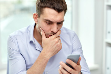 Image showing close up of businessman with smartphone