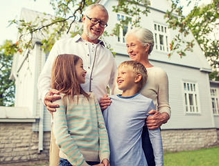 Image showing happy family in front of house outdoors