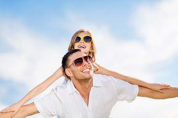 Image showing happy father and child in sunglasses over blue sky