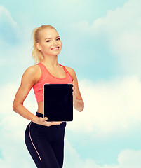 Image showing smiling woman showing tablet pc blank screen