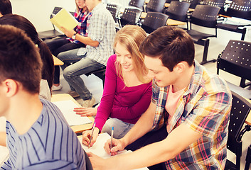 Image showing group of smiling students in lecture hall