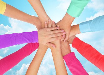 Image showing close up of women hands on top in rainbow clothes