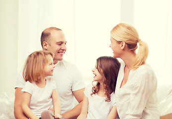 Image showing smiling family with two little girls at home