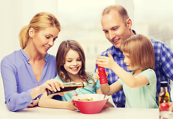 Image showing happy family with two kids eating at home