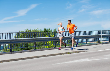 Image showing smiling couple running at summer seaside