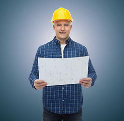 Image showing smiling male builder in helmet with blueprint