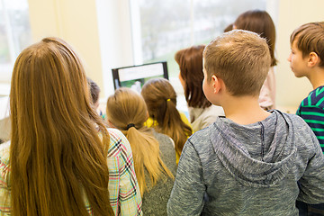 Image showing group of kids with teacher and computer at school