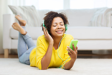 Image showing happy african woman with smartphone and headphones