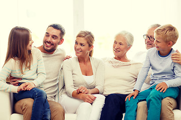 Image showing happy family sitting on couch at home