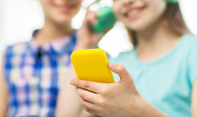 Image showing close up of girls with smartphone and headphones