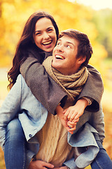 Image showing smiling couple hugging in autumn park