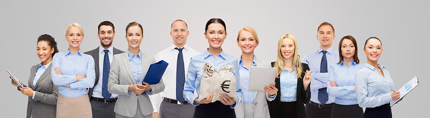 Image showing group of happy businesspeople with money bags