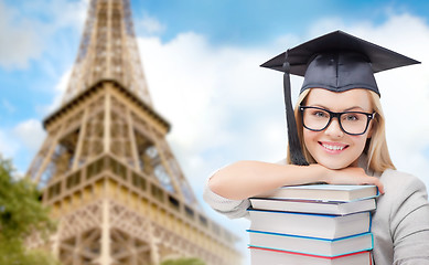 Image showing student in trencher with books over eiffel tower