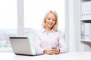 Image showing smiling businesswoman or student with smartphone