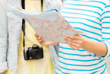 Image showing close up of women with map and camera outdoors