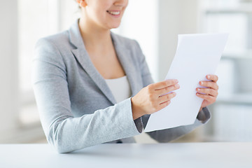 Image showing close up of woman reading papers or tax report