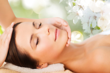 Image showing beautiful woman in spa salon having facial massage